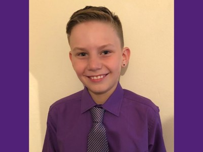 JJ wearing purple and smiling