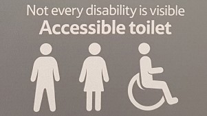 Tesco accessible toilet sign reads "Not every disability is visible".