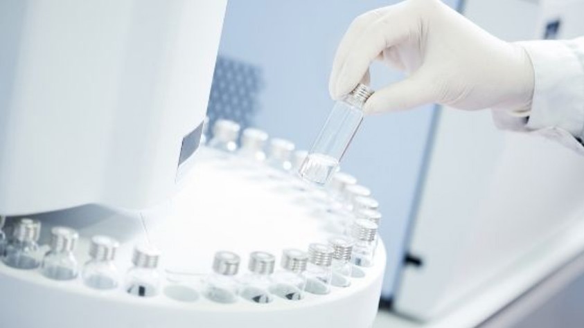 Research Lab - Scientist using medicial tubes in a machine