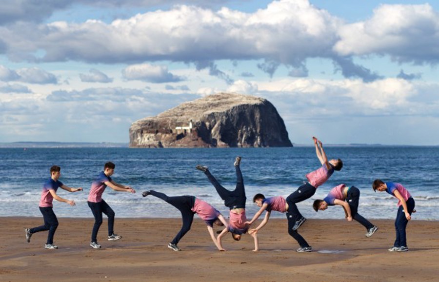 Photo shows Olly on a beach in 8 stages of a flip.