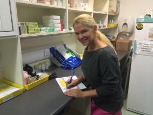 Sister Kay Greveson signing Infliximab prescriptions in the day case pharmacy