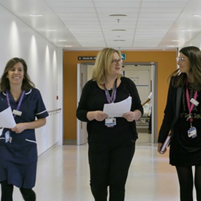 Nurses and practitioners walking down a corridor
