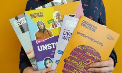 person holding brochures