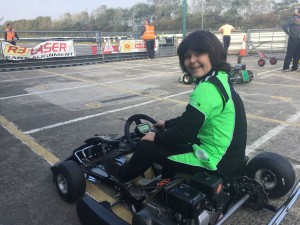 Ben smiling sitting in a go-kart.