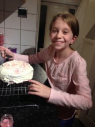 Evie looking happy with her birthday cake