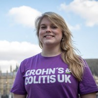 Woman standing in front of the houses of parliament.